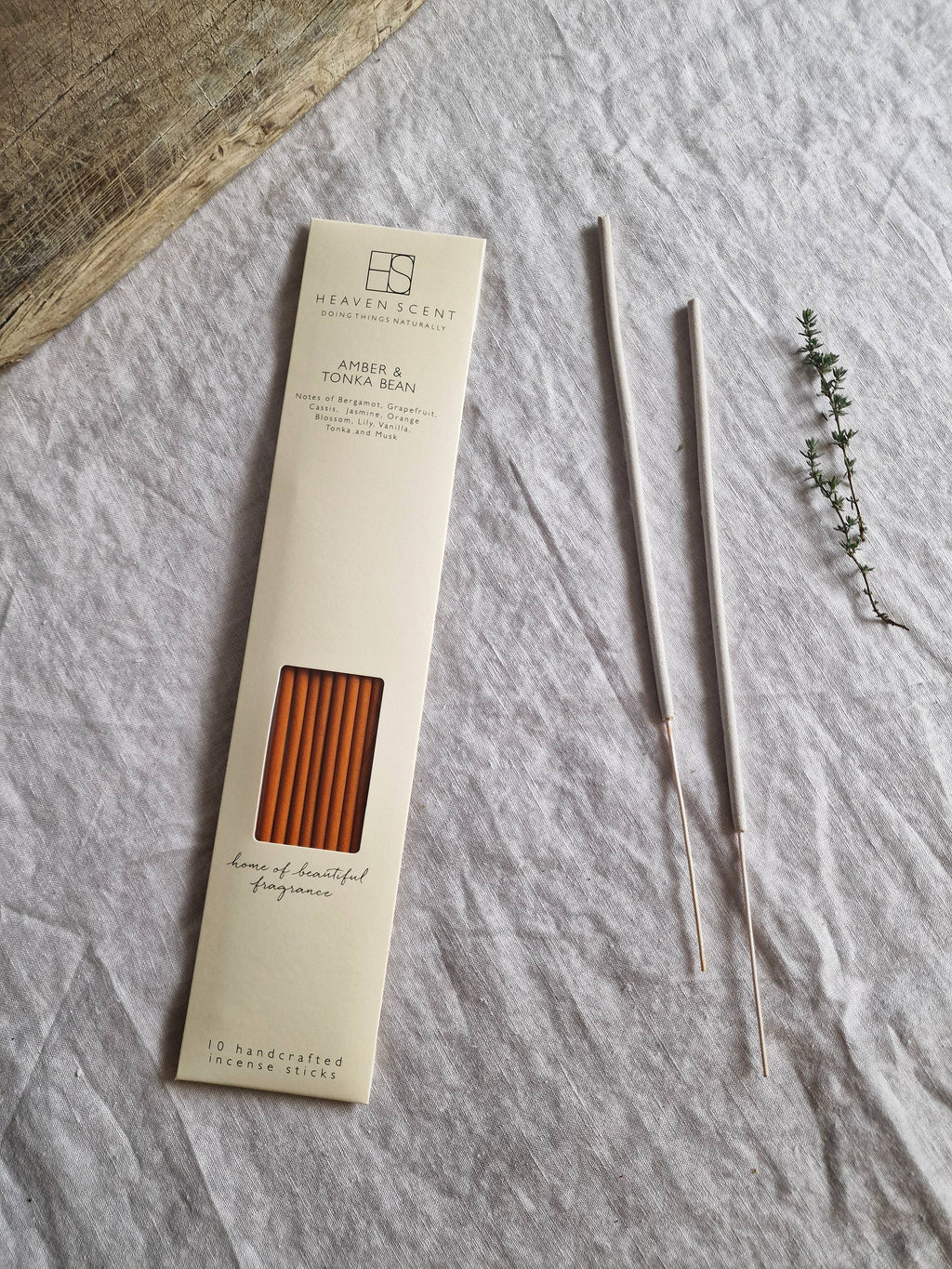 Heaven Scent Amber & Tonka Bean Incense sticks in a cream-colored paper sleeve packaging,