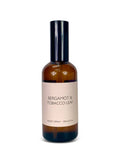 Room spray bottle labeled 'Bergamot & Tobacco Leaf' on a white background