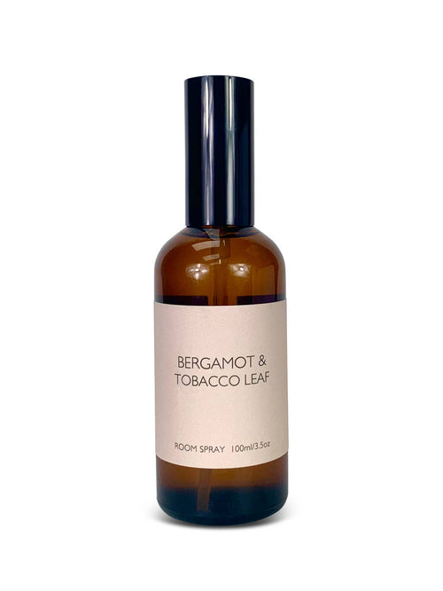 Room spray bottle labeled 'Bergamot & Tobacco Leaf' on a white background