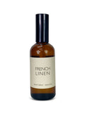 Brown room spray bottle labeled 'French Linen' on a white background