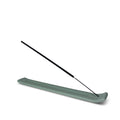Incense holder with two incense sticks on a white background