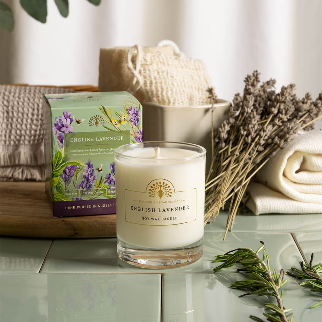 English Lavender candle with packaging on a table with lavender and plants. - The Fig House