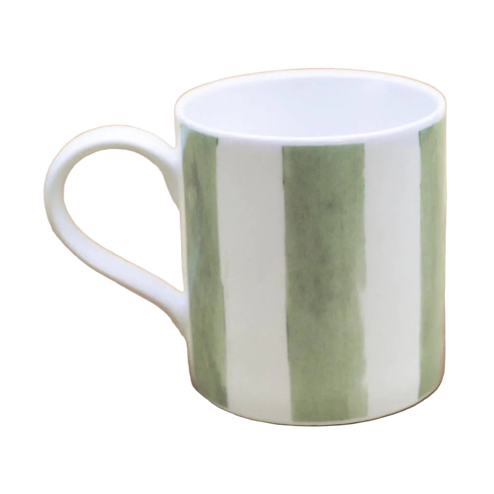 A white ceramic mug with three vertical sage green stripes, set against a solid dusty pink background.