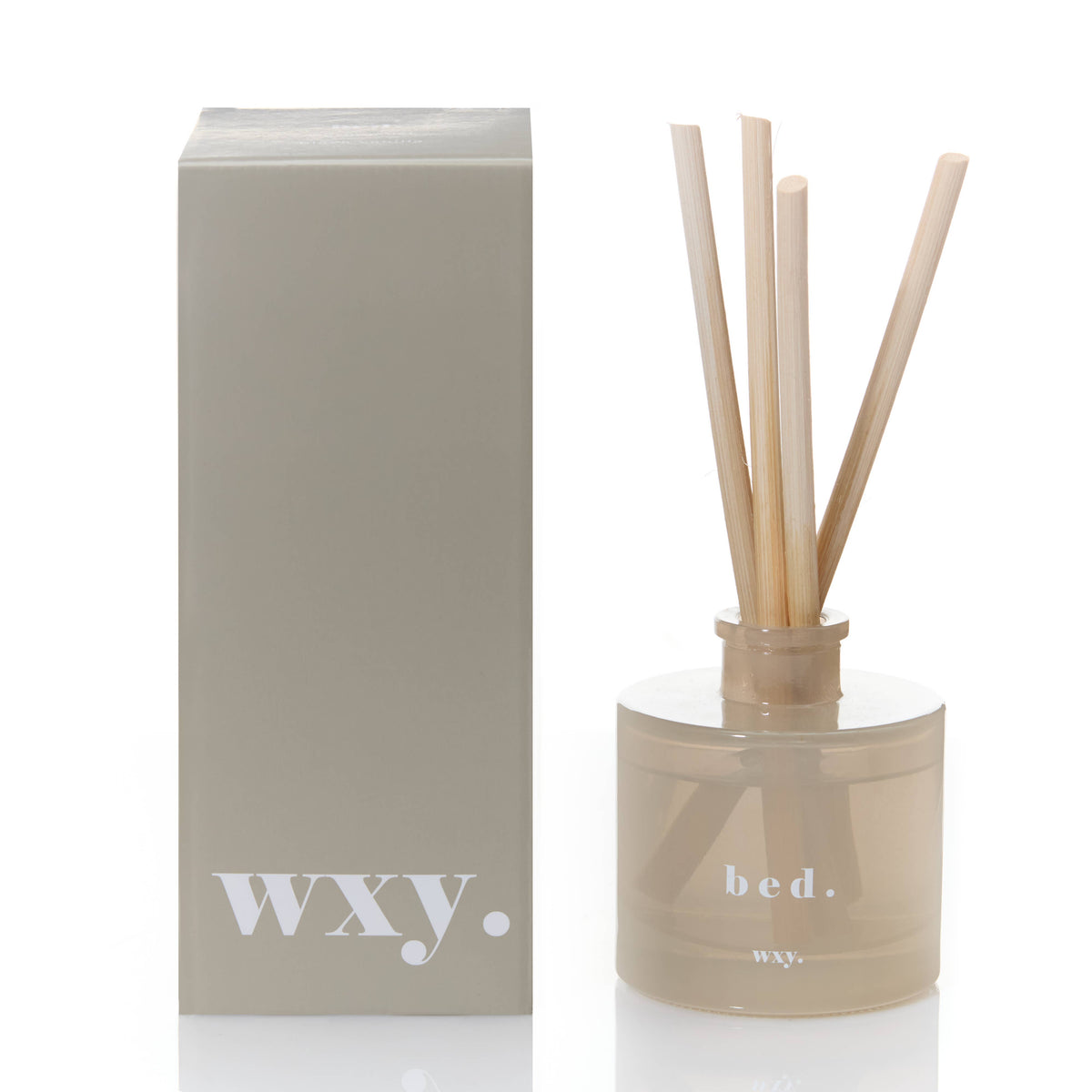 Diffuser with reeds and packaging labeled 'WXY' on a white background