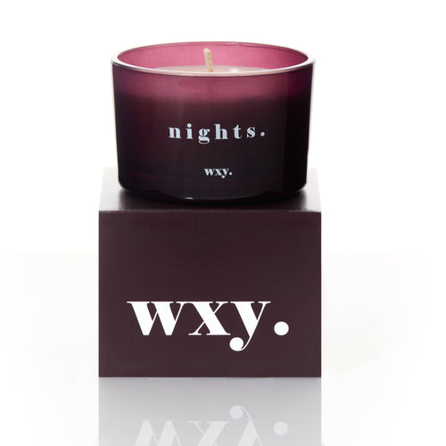 Mauve candle with 'nights.' text on a matching box with 'WXY.' branding.