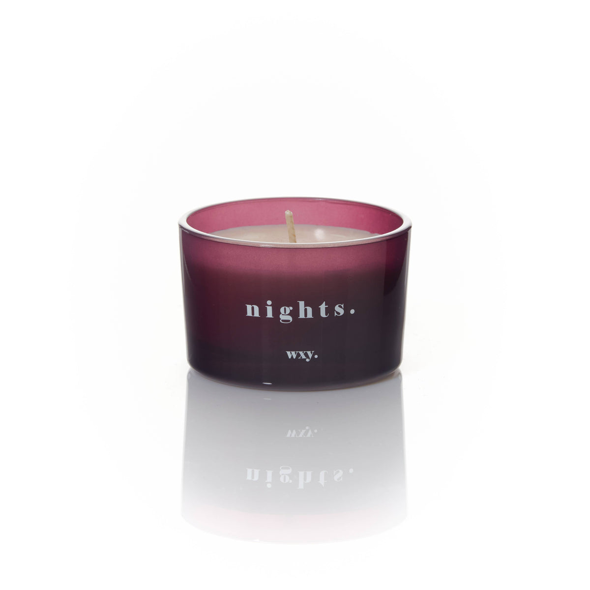 Candle in a purple container with 'nights.' and 'wxy.' text on a white background