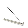 Incense holder with a single incense stick on a white background