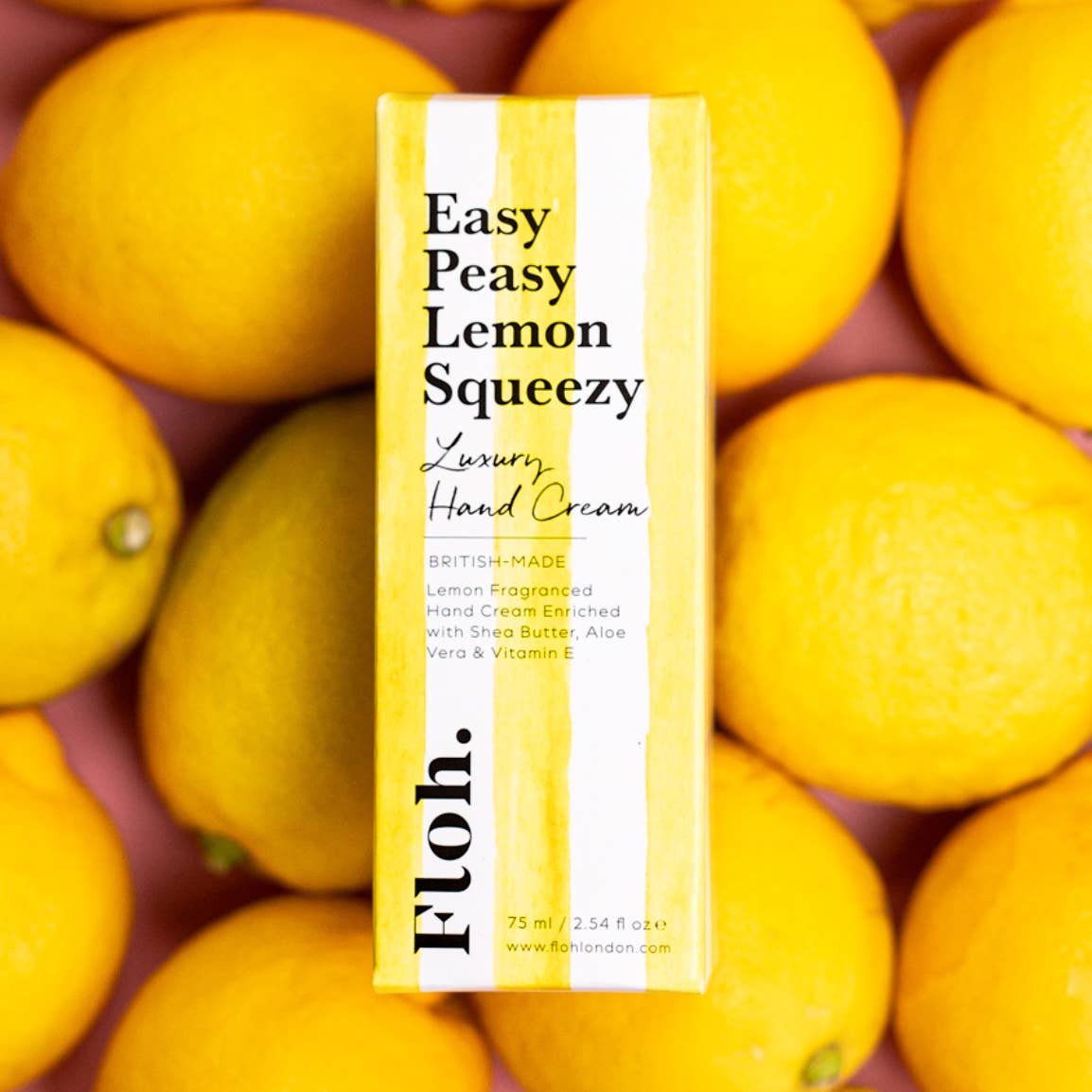Hand cream box labeled 'Easy Peasy Lemon Squeezy' surrounded by lemons