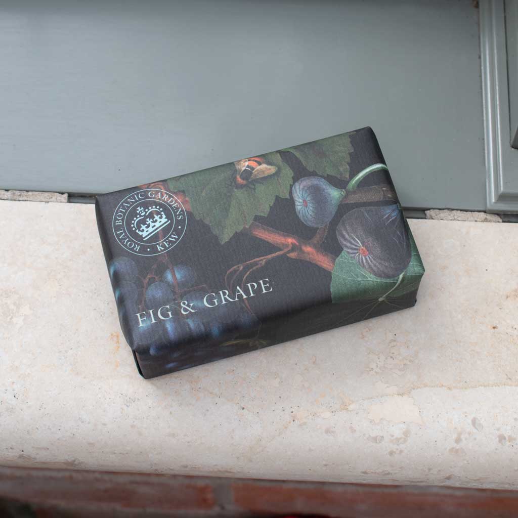 Box of fig and grape-flavored confectionery on a stone surface with a neutral background - The Fig House