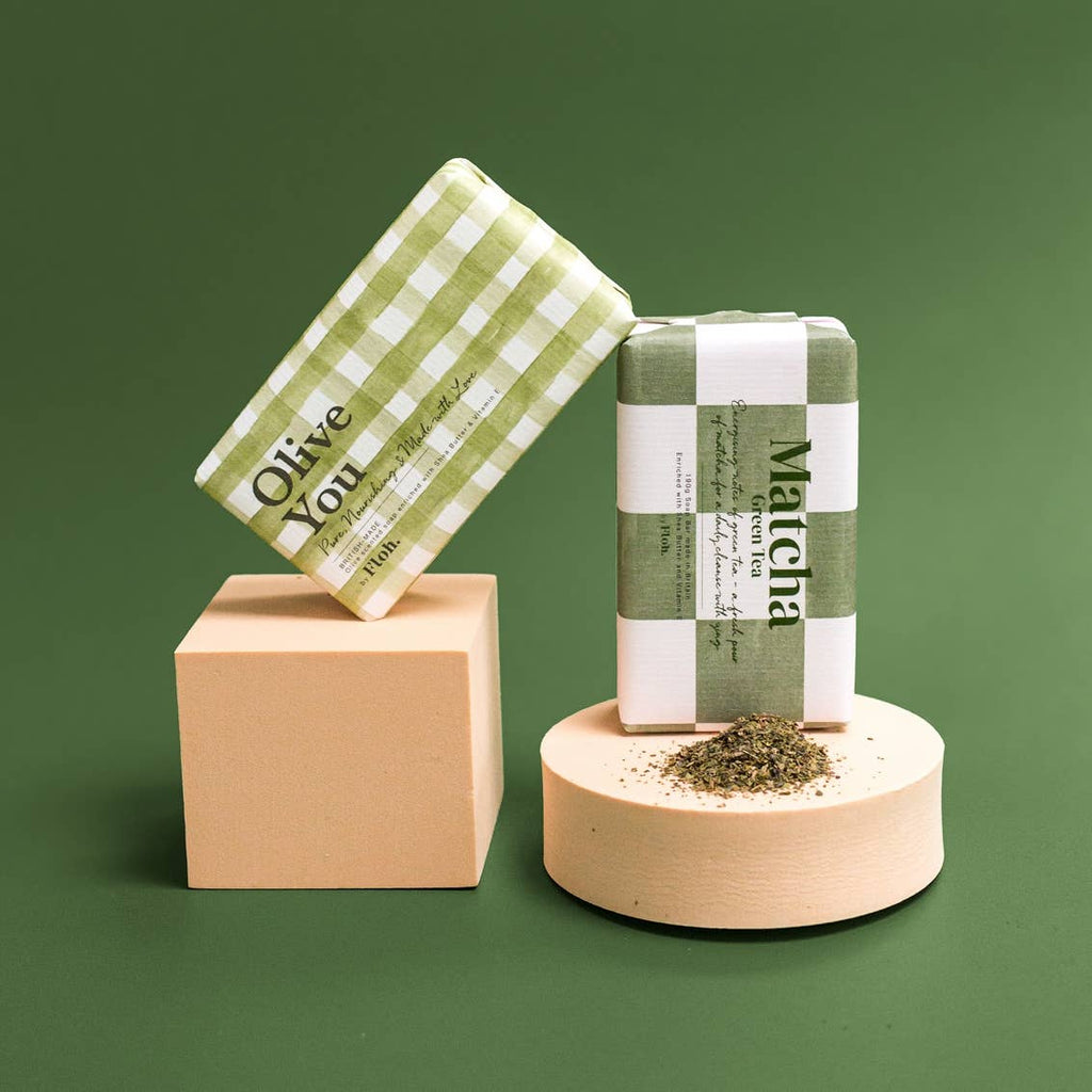Two green and white checkered soap bars with text on a green background