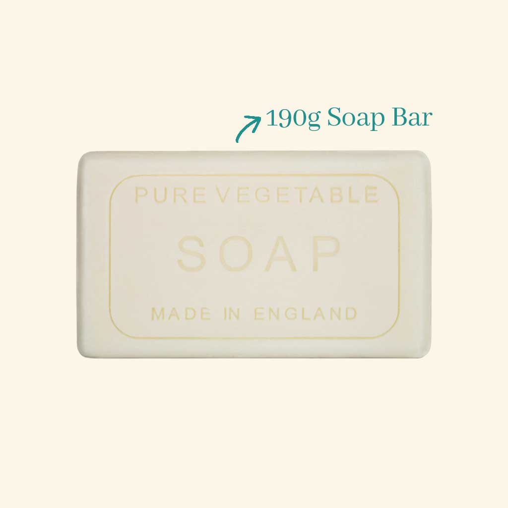Bar of soap labeled 'Pure Vegetable Soap Made in England' with a weight indication on a beige background. - The Fig House