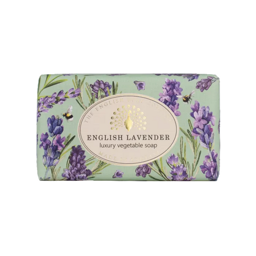 A rectangular bar of English Lavender luxury vegetable soap by The English Soap Company, wrapped in a light sage green paper sleeve decorated with purple lavender flowers, green leaves, and a central cream-colored oval label with gold foil detailing. - The Fig House